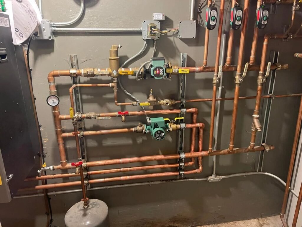 Homeowner checking the pressure gauge on a boiler in a home basement